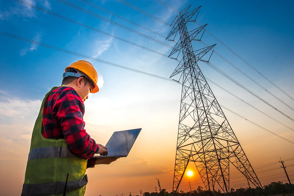 Technician examining power lines